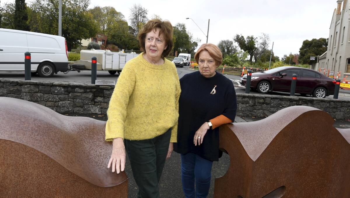 Buninyong residents Bernadette O'Loughlin and Mitza Clark standing at the roundabout, crash site in the background. Photo Lachlan Bence