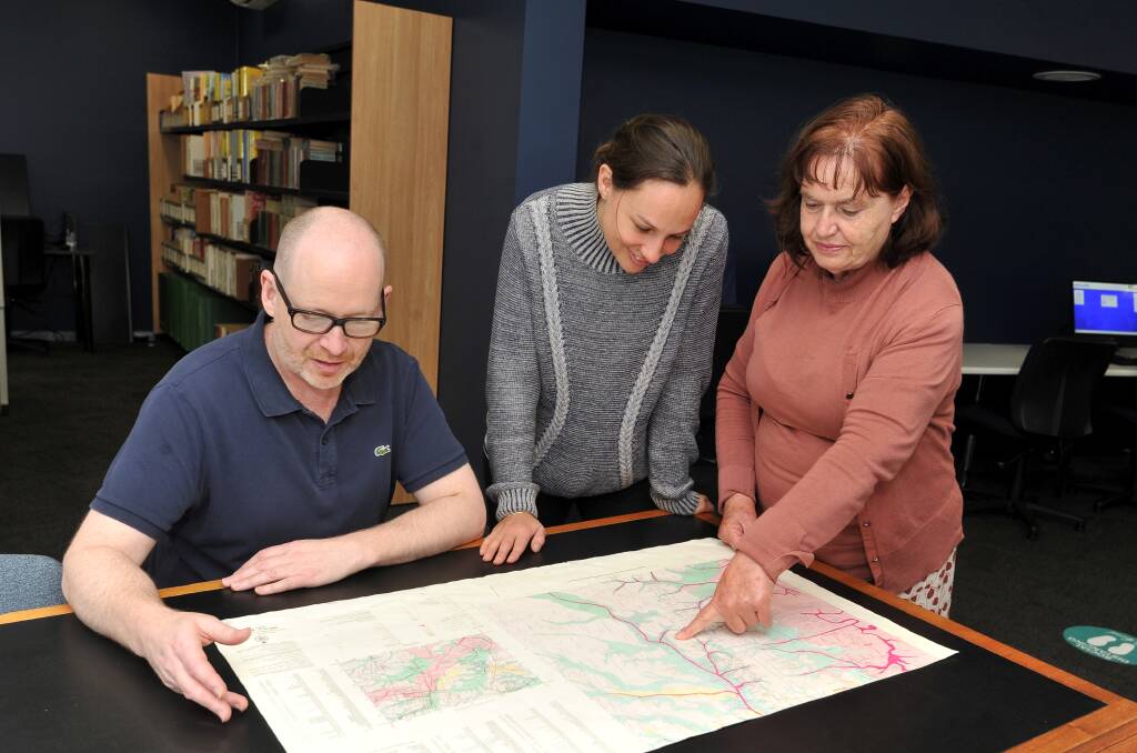 RESEARCH: Anthony Camm, Amy Tsilemanis and Marlene Cantwell look over historical documents at the Eureka Centre. Photo: Lachlan Bence