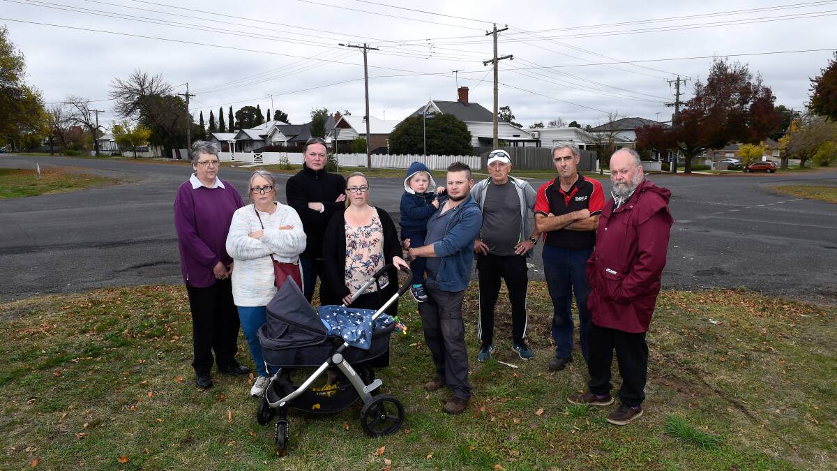 Neighbours Kathleen Robertson, Sarah Kernighan, Darron Farquhar, Brooke Muller with baby Harry, Dan Clarke with Jack, Peter Bray, John Stevens and Peter Waugh at the Darling-Talbot Street intersection in 2022. Photo by Adam Trafford