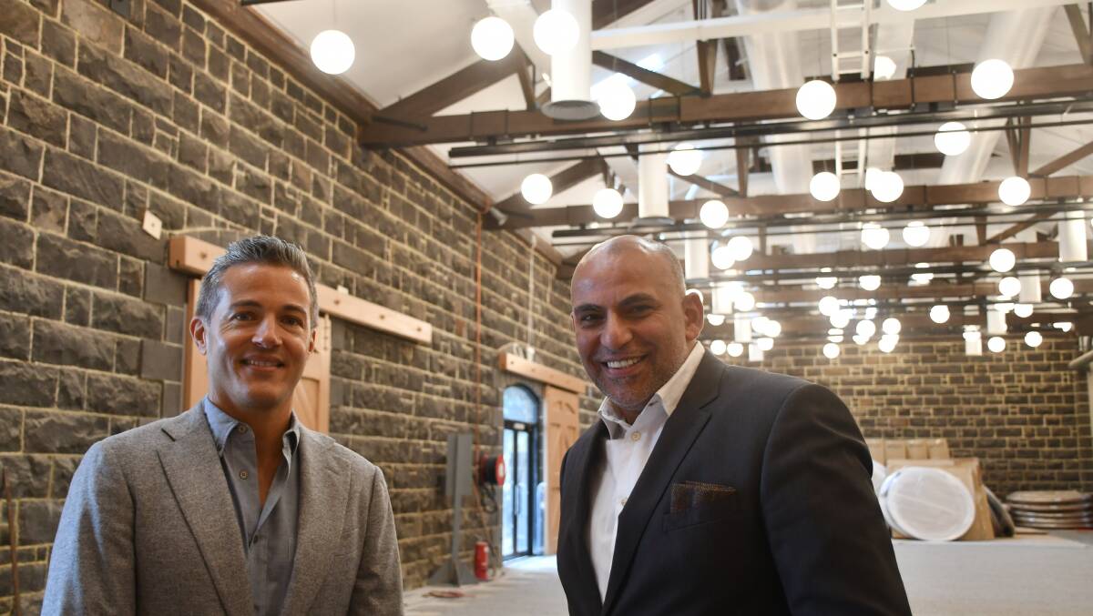 Goods Shed developer Nando Pellicano and Atlantic Group chief executive Hatem Saleh inside one of the new function rooms. Picture by Luke Hemer. 