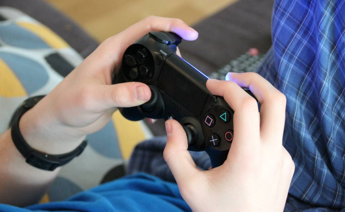 A man in his 20s' has been charged after he blackmailed a child to send him naked photographs through a video game they both played. Stock image. 