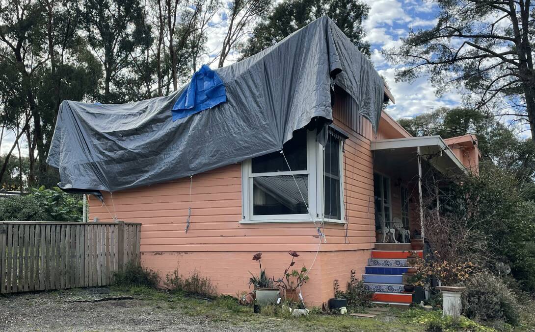 Sandy Campbell's insurer, Australian Seniors, has used tarp as a temporary fix for the hole in her roof which was caused by the January floods.