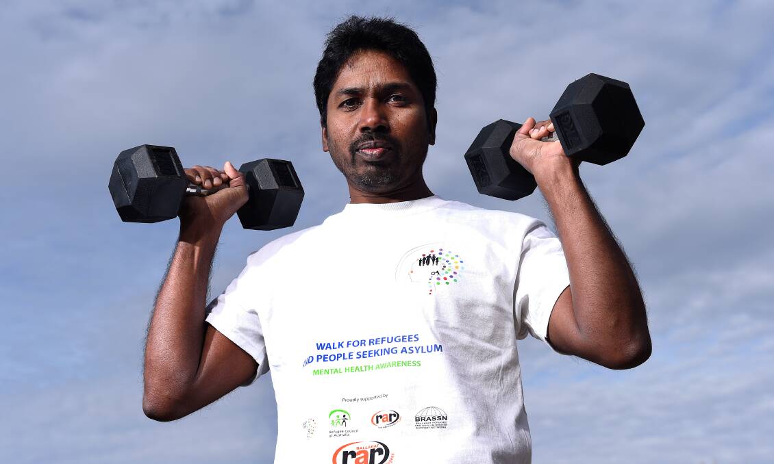 ADVOCATING FOR CHANGE: Neil Para, a Tamil asylum seeker living in Ballarat carried 20.25kg while walking around Lake Wendouree to signify the plight his family and other asylum seekers faced living in 'limbo.' Picture: Adam Trafford.