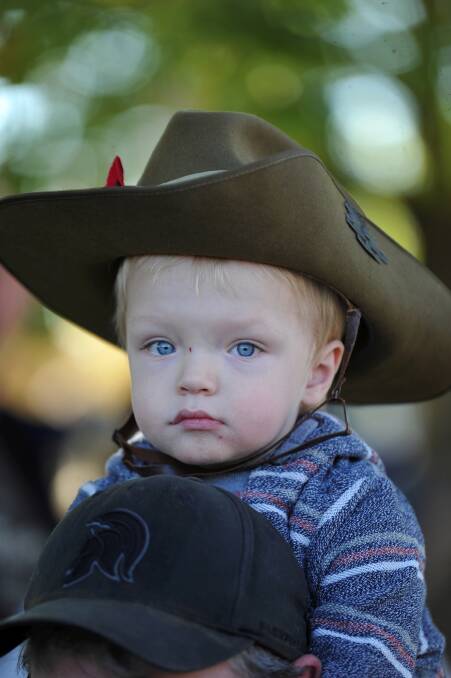 ALL AGES: Two-year-old Riley Rogers at the Anzac commemorative service. Photos: Lachlan Bence