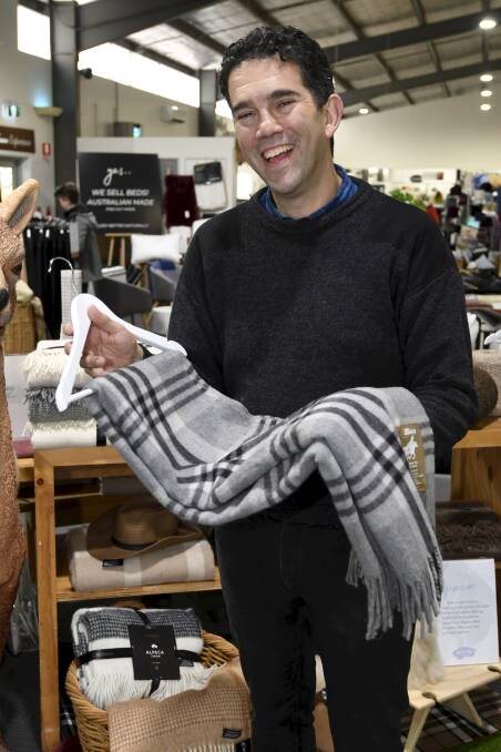 CREATION: Creswick Woollen Mills executive director Boaz Herszfeld with a recycled throwrug. Picture: Lachlan Bence.