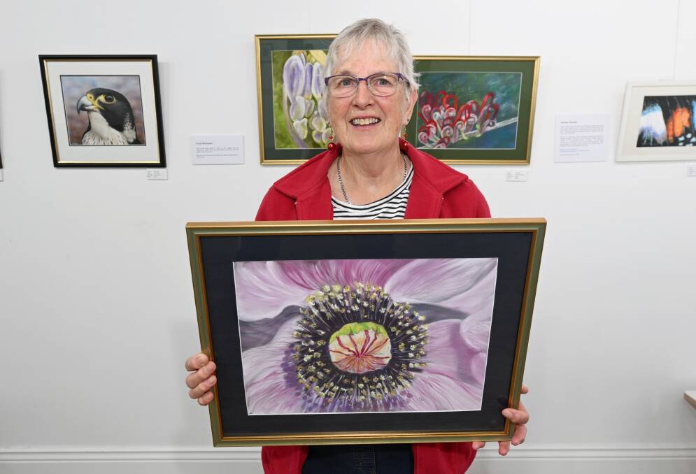 Ballarat Society of Artists president Trudy Nicholson with her work, part of Golden Futures: a macro view in the Art Space. Picture by Lachlan Bence