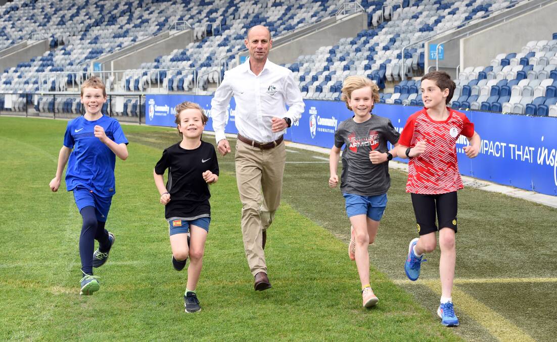 Steve Moneghetti goes for a run with Ballarat's future athletes at Mars Stadium. Picture by Kate Healy