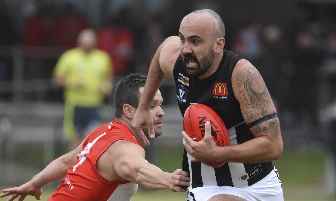 Darley's Trent Angwin escapes from Ballarat's Andrew Hooper on Saturday. Picture by Lachlan Bence