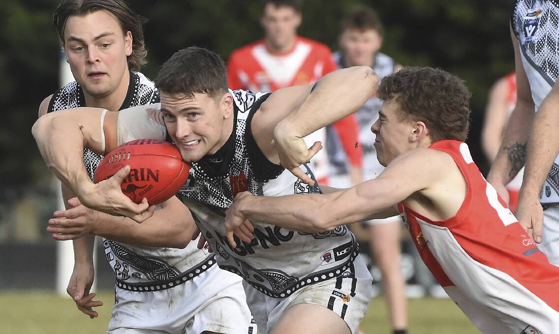 North Ballarat's Brock Leonard breaks through the tackle. Picture by Lachlan Bence