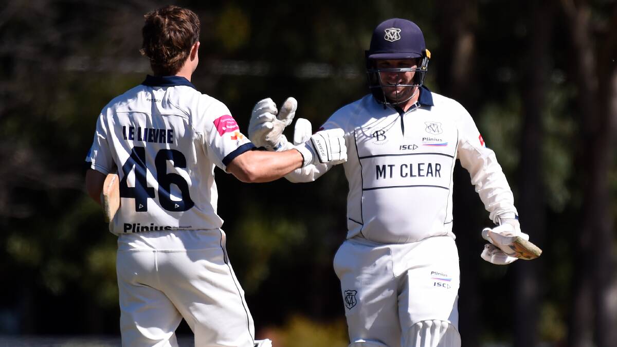 Mt Clear's Jacob Smith (right) congratulates Thomas Le Lievre on his century in the Mounties' win over Ballarat-Redan. Picture by Adam Trafford