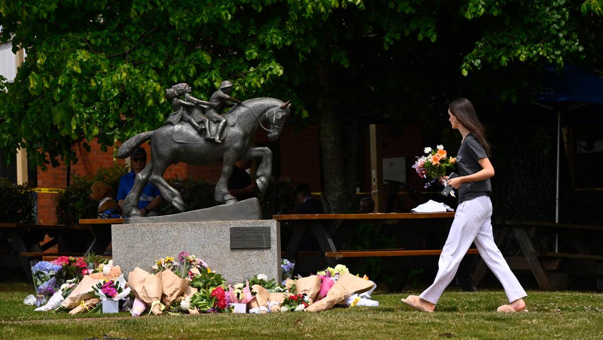 This Daylesford statute - honouring children and horses - has become a makeshift shrine to the four who died just metres away - and a fifth child who died in hospital. Picture by Adam Trafford. 