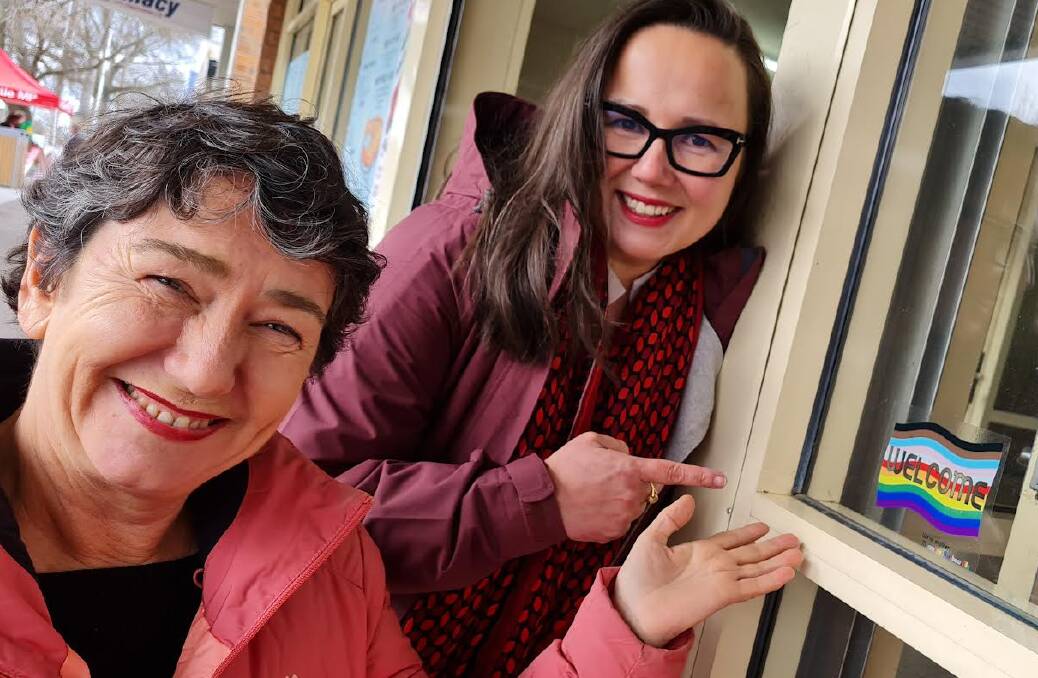 Eureka MP Michaela Settle and Equality Minister Harriet Shing with one of the welcome stickers at a Ballan take-away shop. Picture by Gabrielle Hodson.