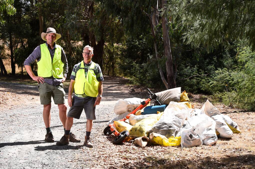 Anthony Handley from the leigh Catchment Group and Clean Up Australia Day Redan Wetlands-Yarrowee River co-ordinator Col Palmer check out the pile of litter they collected from the river including an e-scooter. Picture by Adam Trafford. 
