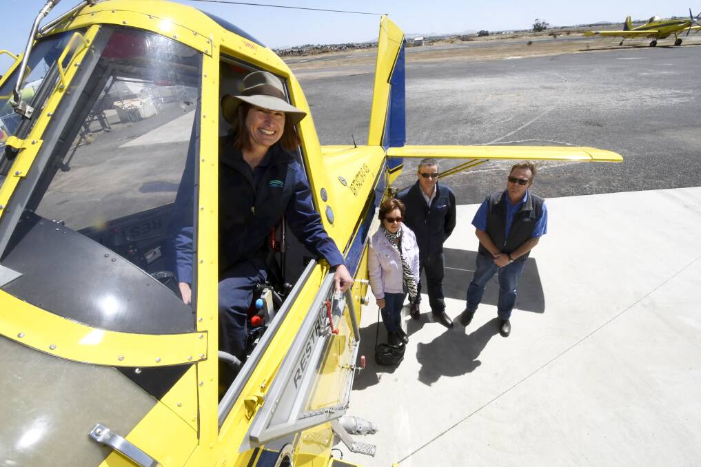 Jessica Miller from the Corangamite Catchment Management Authority checks out the pilot's seat at Ballarat Airport with consultant Dr Barbara Wilson, Field Air Group General Manager Stephen Holding and chief pilot Stephen Rossington. Picture by Lachlan Bence.