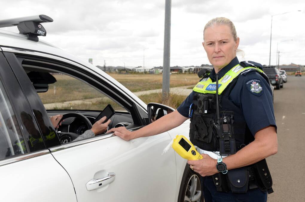 First Constable Darlene Hatchett catches a distracted driver red-handed as Operation Arid gets going this Labour Day long weekend. Picture by Kate Healy.