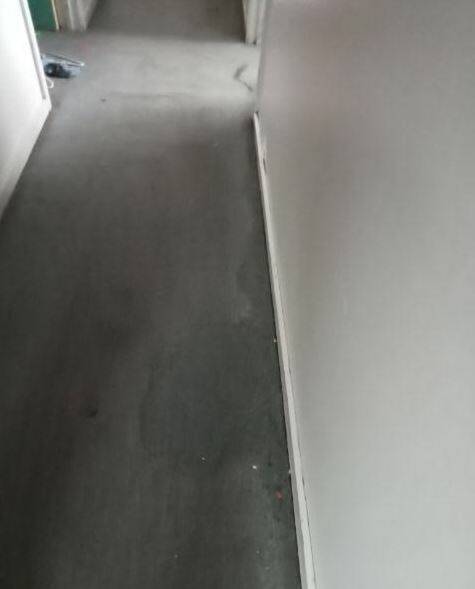 This hallway carpet was stained and mouldy before it was removed last week. The process of removal also revealed holes in the walls and the rotting framework underneath. Picture by Lisa Tester.