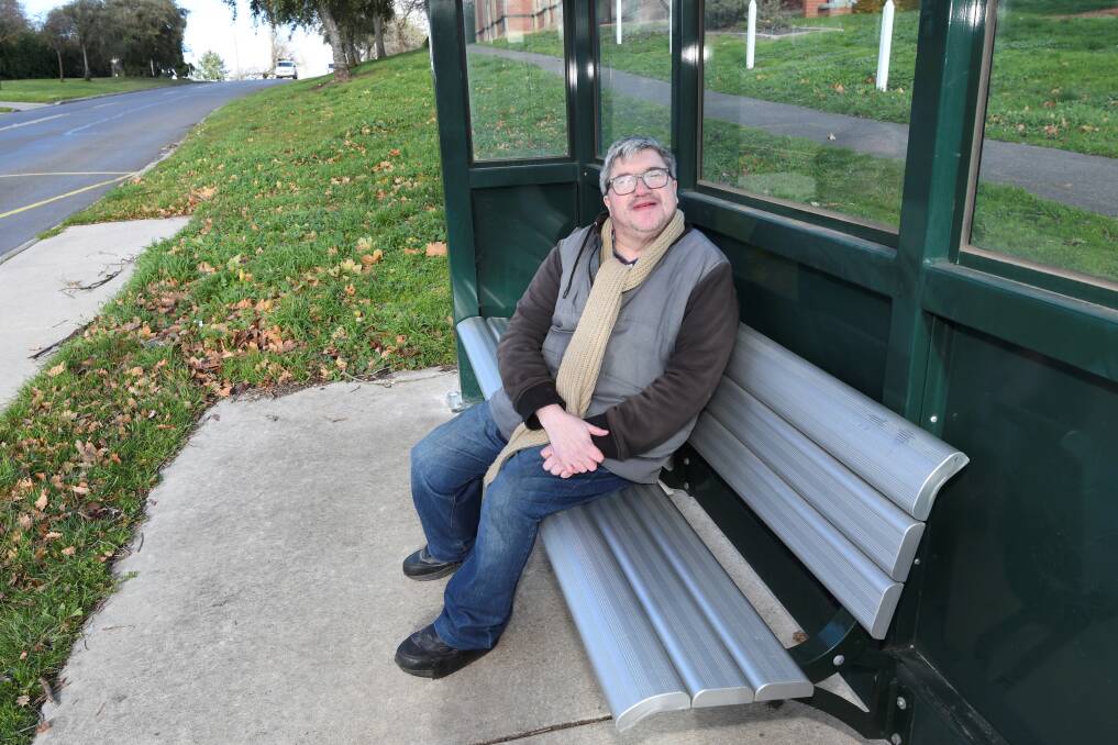 Bunninyong resident Barry Devine sitting at the Warrenheip road bus shelter he campaigned to have built. Picture by Lachlan Bence