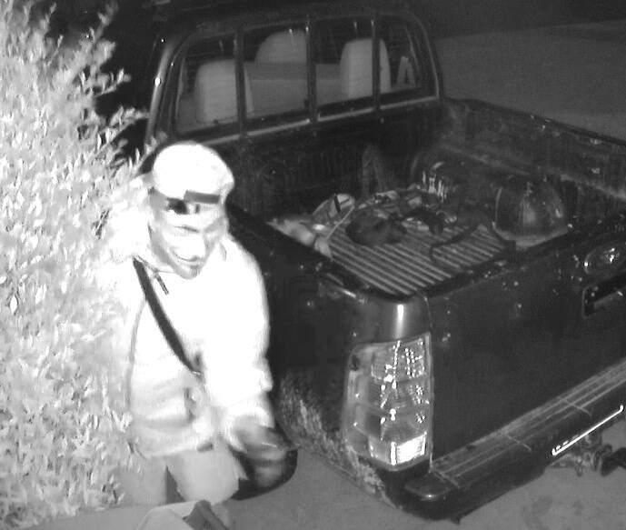 A masked man has been captured on CCTV inspecting a car in Wendouree. Picture supplied