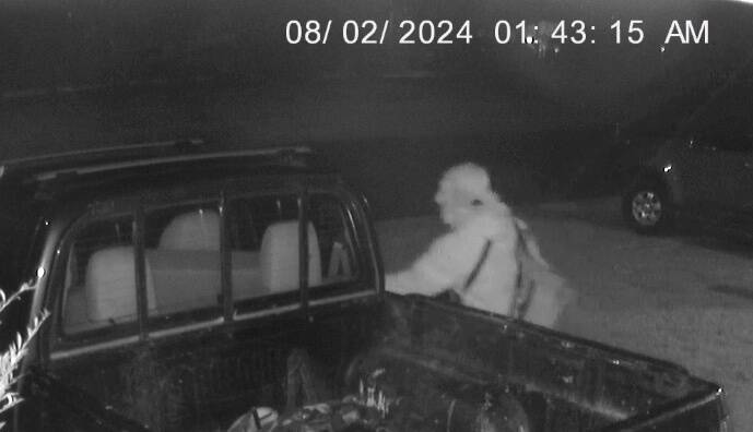 A masked man has been captured on CCTV inspecting a ute about 1:43am. Picture supplied