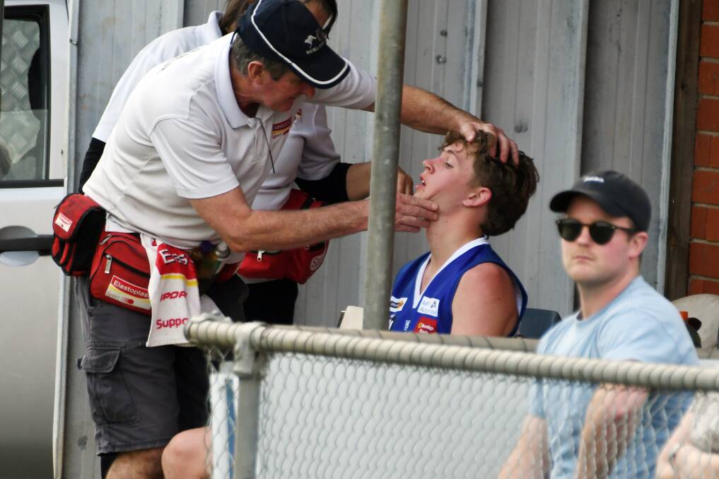 Waubra player Bailey Colligan is checked for concussion in 2021. Picture by Kate Healy