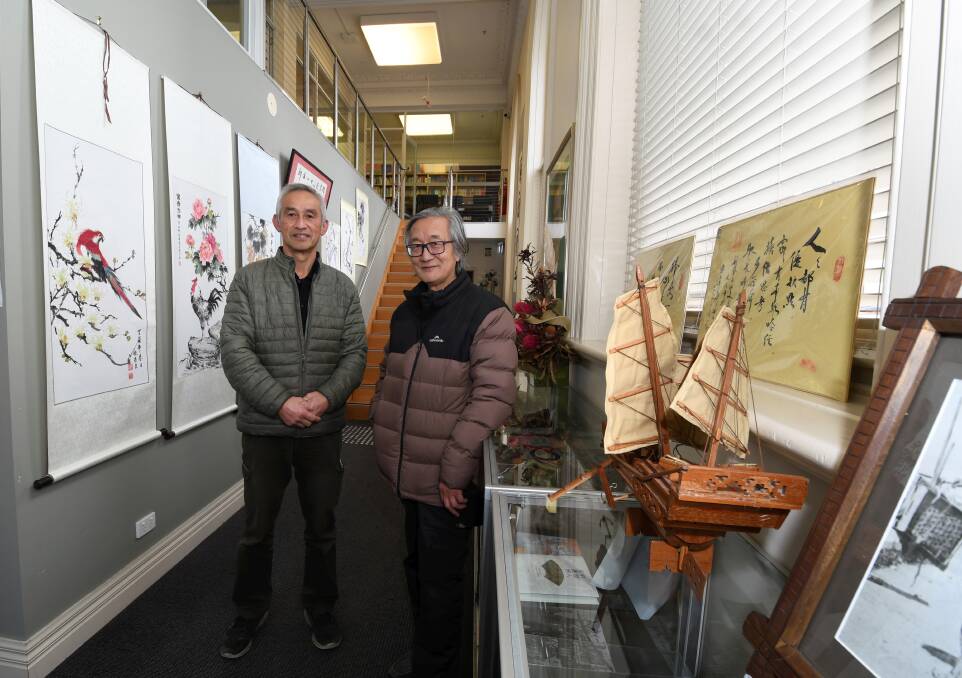 Charlies Zhang and Haoliang Sun are in the Xin Jin Shan Chinese Library. Picture by Lachlan Bence