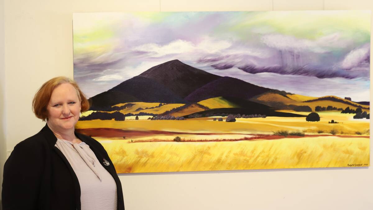 Artist Angela Gerrard with one of the exhibited artworks Mount Cole on a Misty Day. Picture supplied 