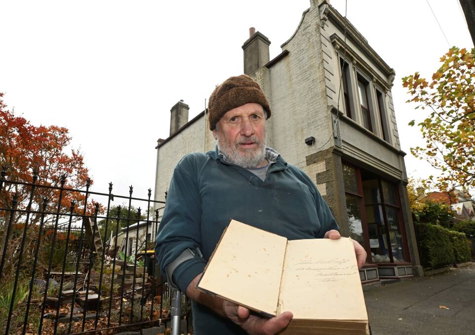 Owner of Lydiard Street Antiques, Peter Willis, returned a book to its home after 150 years. Photo by Lachlan Bence