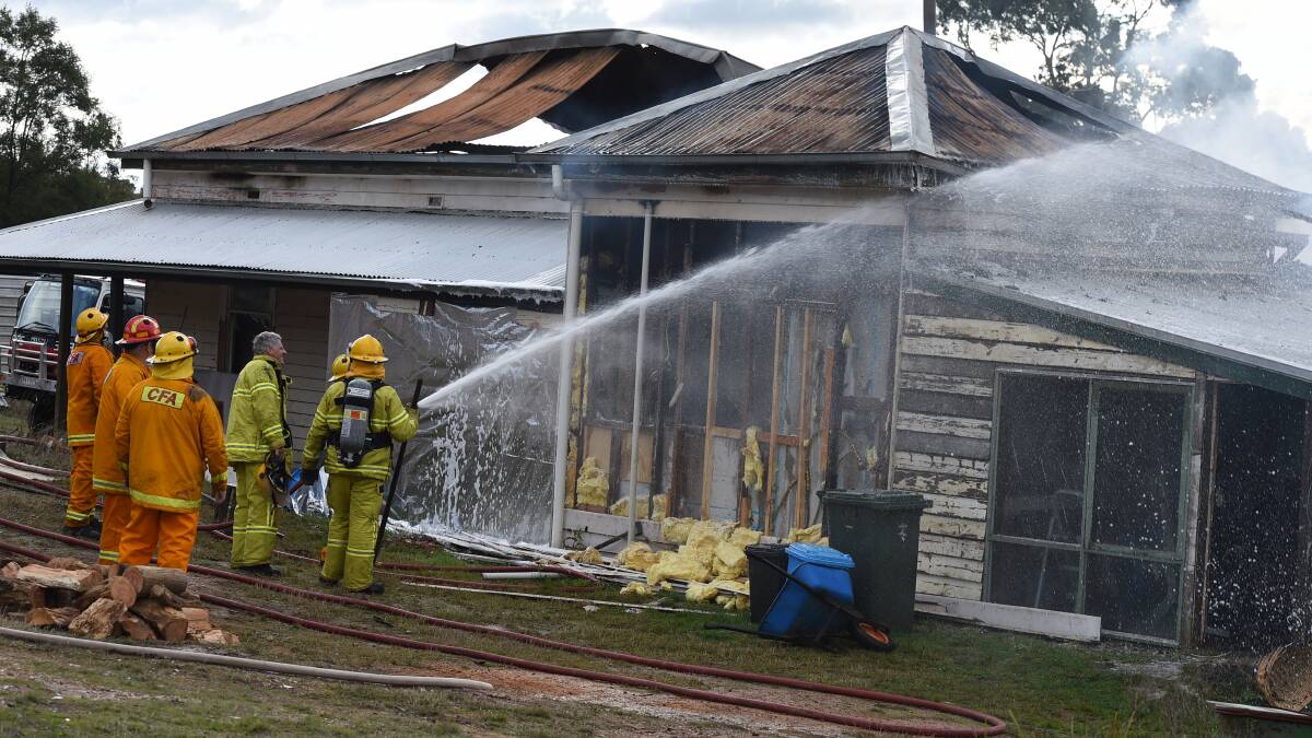 DESTROYED: Fire fighters battle to extinguish a Snake Valley house fire on Wednesday. PICTURE: LACHLAN BENCE