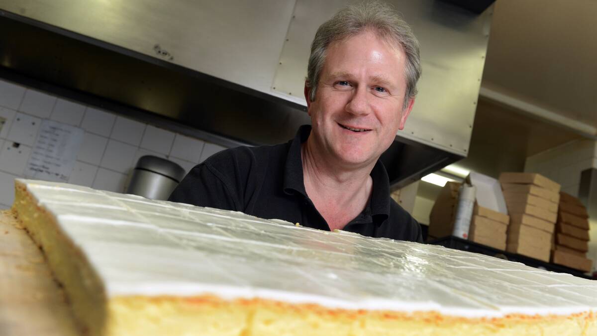 DELICIOUS: Golden Nugget Bakery owner Colin Matthews tucks into one of the bakery's award-winning vanilla slices. Picture: Kate Healy.