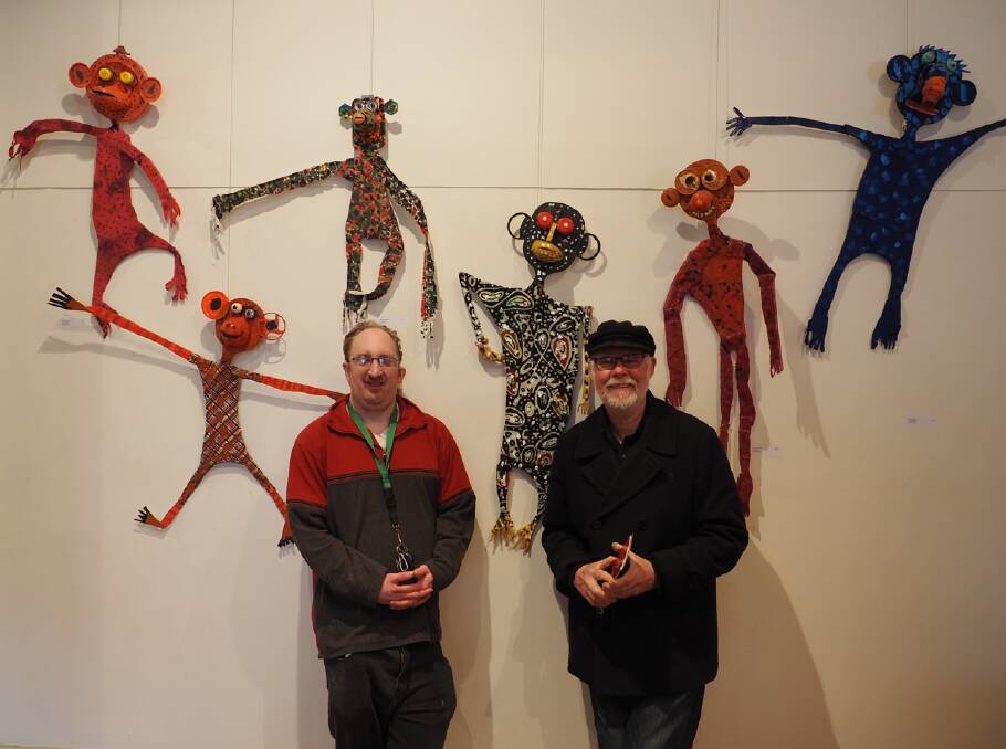 QUIRKY ART: Artist Tim Sedgwick and collaborator Geoff Bonney enjoy the Monkey Wall at the Tim Sedgwick Sculpturals exhibition. Picture: Supplied