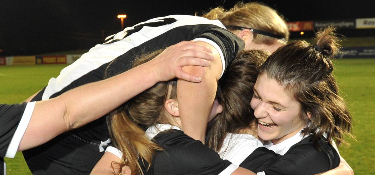 PARTY TIME: North United White's Jasmine Joyce is swamped by teammates as the final whistle blows, with her side beating Warrnambool 1-0.