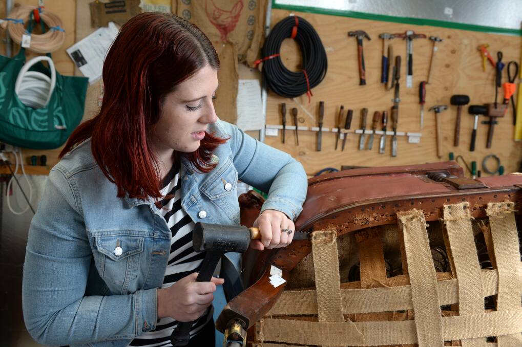 Latest project: Ms Teed hard at work restoring a chair to give it new life.