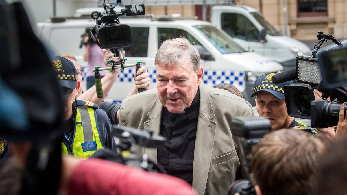 Cardinal George Pell surrounded by media at the County Court in Melbourne. Photo: Justin McManus.