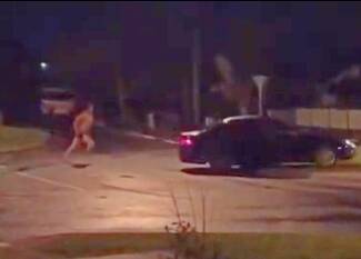 A still from the video of an almost naked man running after a hooning vehicle in Redan.