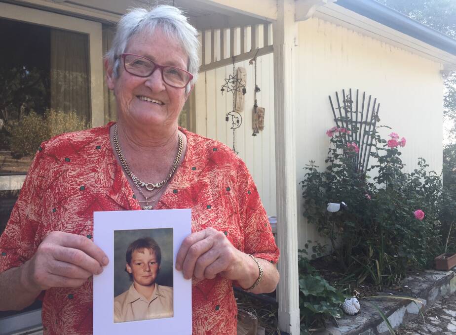 SHOCKED: Helen Watson, with a photo of her son Peter, is disgusted a new parish has been named after a place in the US where Paul David Ryan is facing charges.