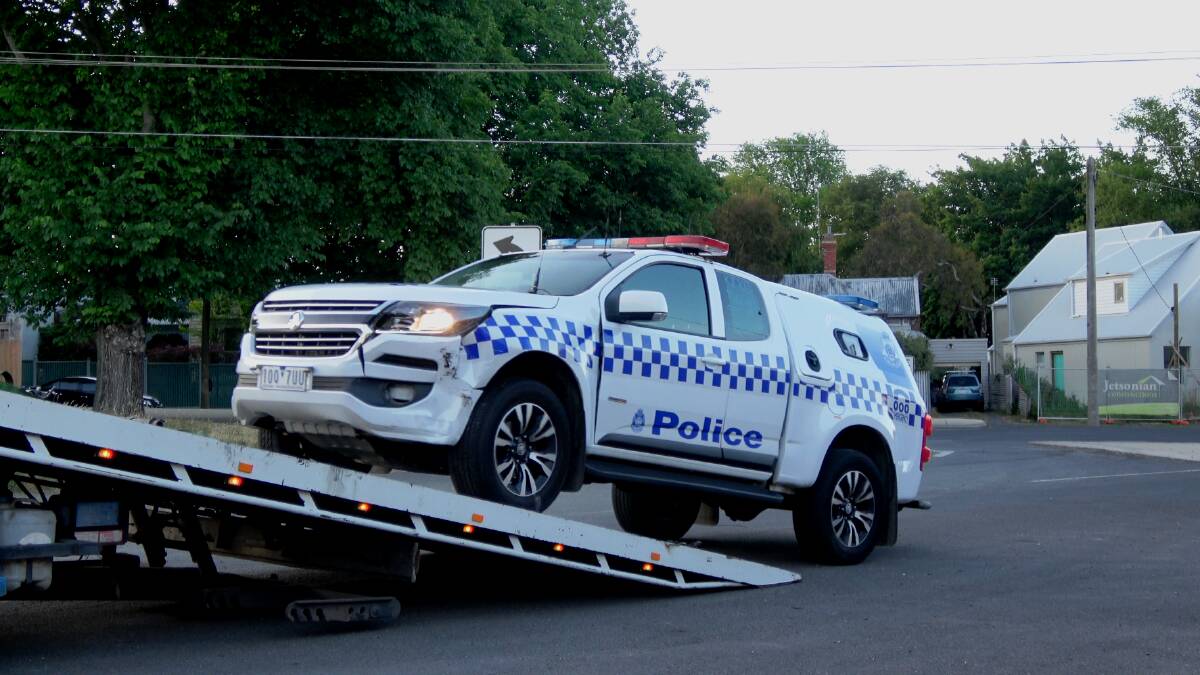 The police car getting towed. Police cars are now covered in protest messages as a part of police industrial action. Photo: 9 News.