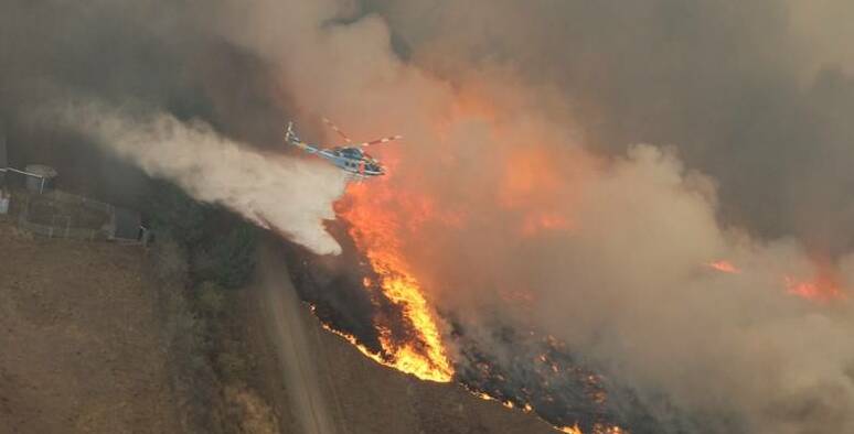 A helicopter helps tackle yesterday's blaze. Picture: Wayne Rigg, the CFA.