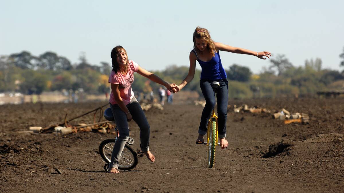 DRY DAYS: Hayley and Samantha Rankin reckon they are probably the first people to ever unicycle on the dry bed of Lake Wendouree (photo taken in April, 2007).