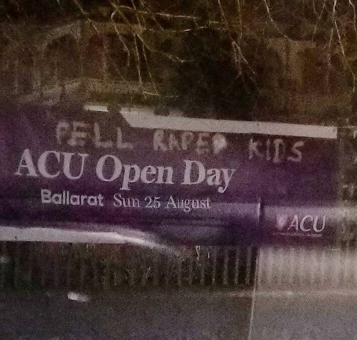The defaced banner at on the Mair Street side of the Ballarat ACU campus.