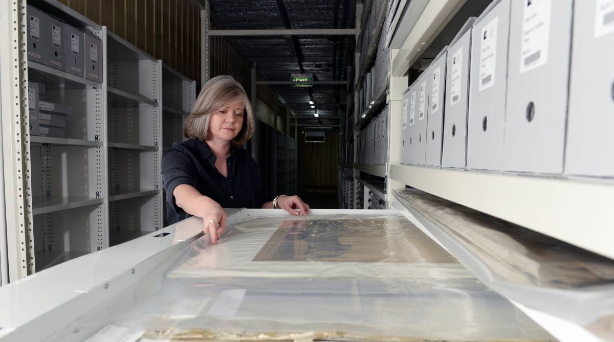 HISTORY CAPTURED: State Library manager of storage and digital services Sarah Slade examines historic architectural drawings of the Ballarat Base Hospital. Picture: Kate Healy.