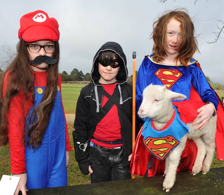 SUPERHEROES: Napoleons Primary pupils Cayla, 10, Miles, 9, Willow, 12 and Timmy the sheep took part in an annual walkathon on Friday which raises money  camps for the school's more than 100 children. Picture: Lachlan Bence.