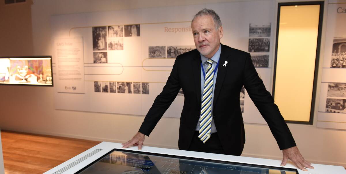 HISTORIC MOMENT: CAFS chief executive officer Allan Joy unveils a interactive digital timeline of the organisation's history. Picture: Lachlan Bence.