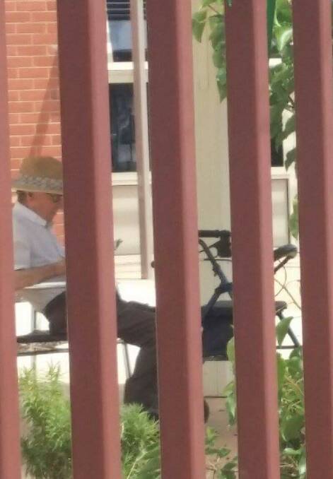 Bishop Ronald Mulkearns was spotted reading outdoors at a nursing home.