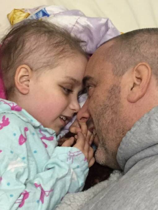 A FATHER'S LOVE: Seven-year-old Hayley, who has a rare form of cancer, with her dad Andrew Brown. A fundraiser is being held in Ballarat for the family next month.  
