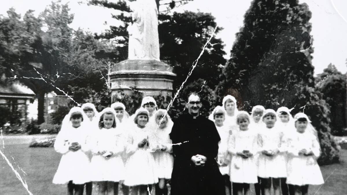 Gerald Ridsdale with a group of the girls making their communion in 1963.