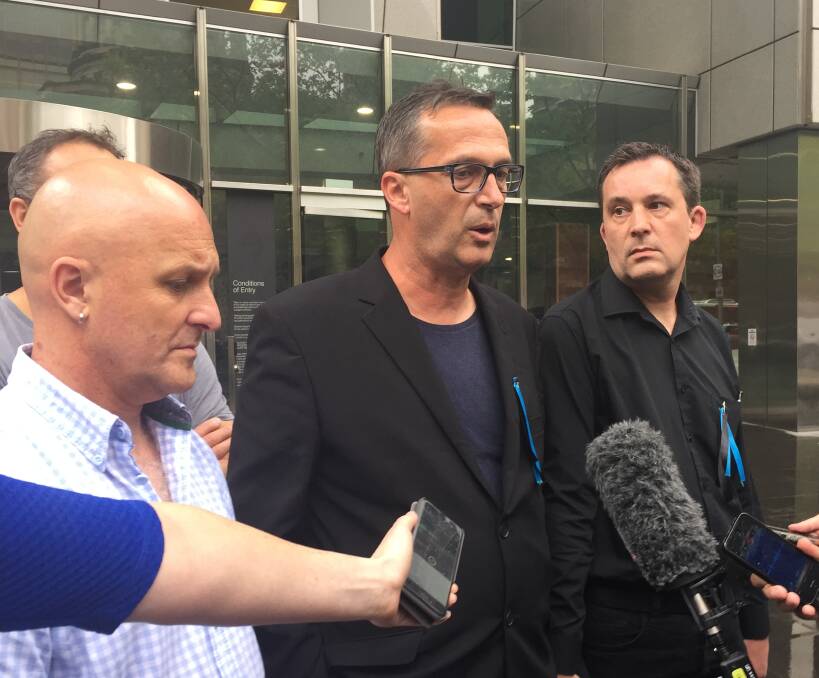SHOCKED: Clergy sex abuse survivors Andrew Collins and David Ridsdale outside the County Court with supporter Daniel Mellmann after news broke Cardinal George Pell would no longer front the inquiry. Picture: Melissa Cunningham 