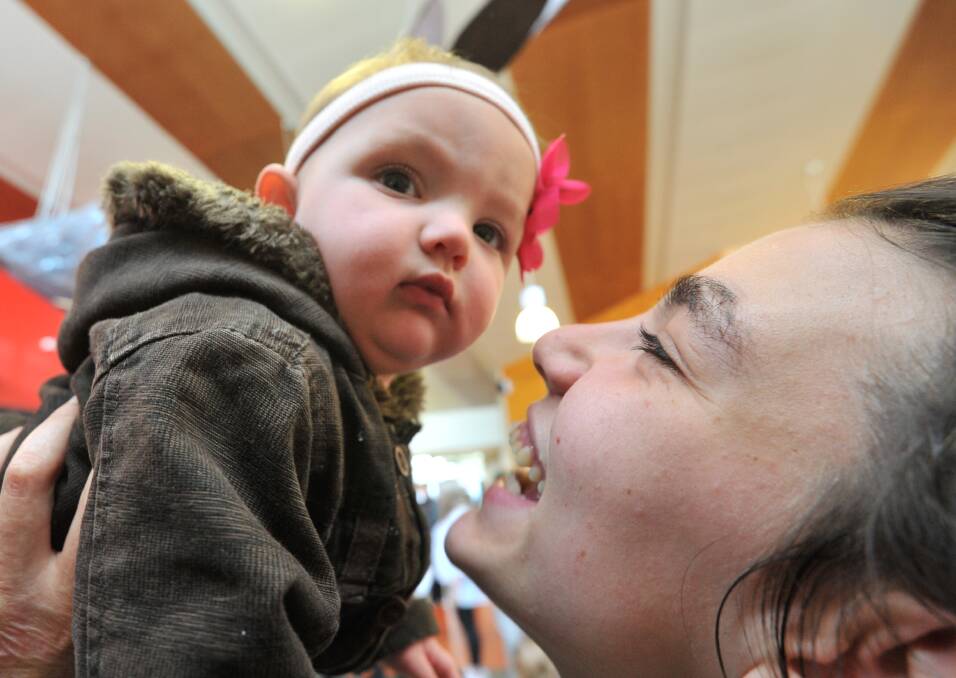 A MOTHER'S TOUCH: Nine-month-old Kitana shares a special moment with her mum Kaylah Smith.  Picture: Lachlan Bence. 