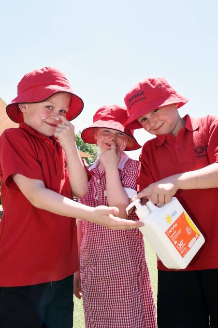 SMART: Ballarat North Primary School pupils Declan, Lauren and Charlie slop on some sunscreen. Picture: Kate Healy