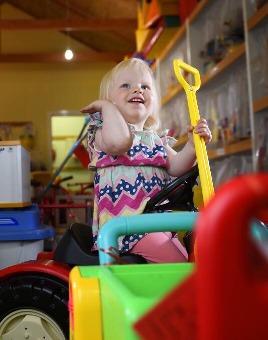 SMILES: Maisie Wardle enjoys the Ballarat Toy Library in 2015. Picture: Luka Kauzlaric