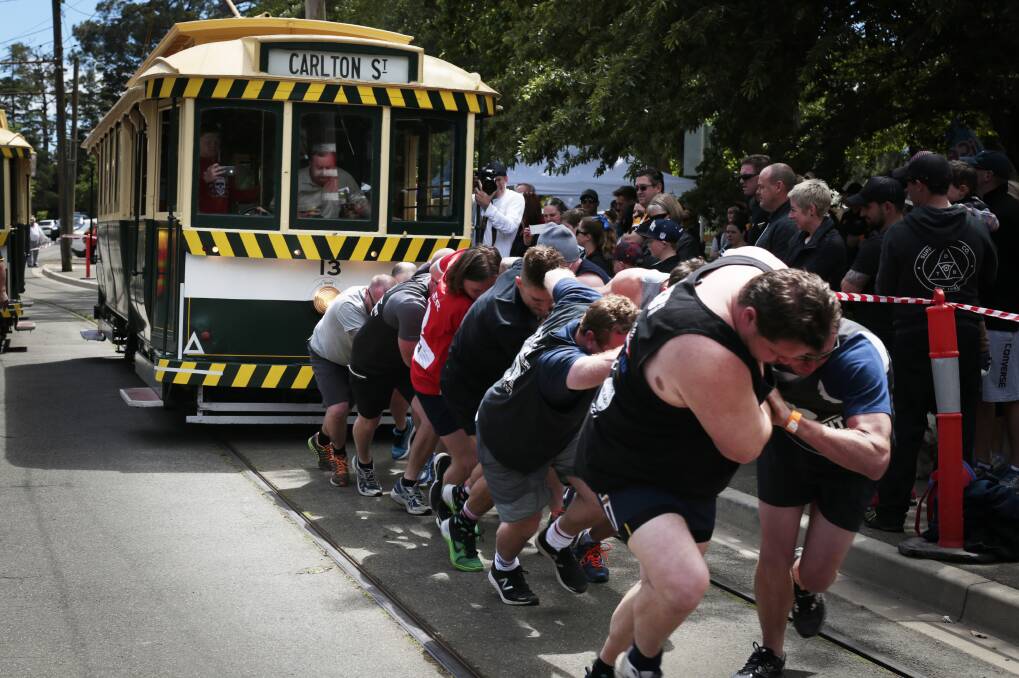 HARD SLOG: Competitors in the team tram pull competition during Springfest in 2016. Picture: Luka Kauzlaric